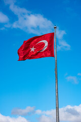 Turkish Flag waving in blue sky.