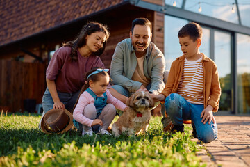 Happy family with  dog enjoying in spring day outdoors.