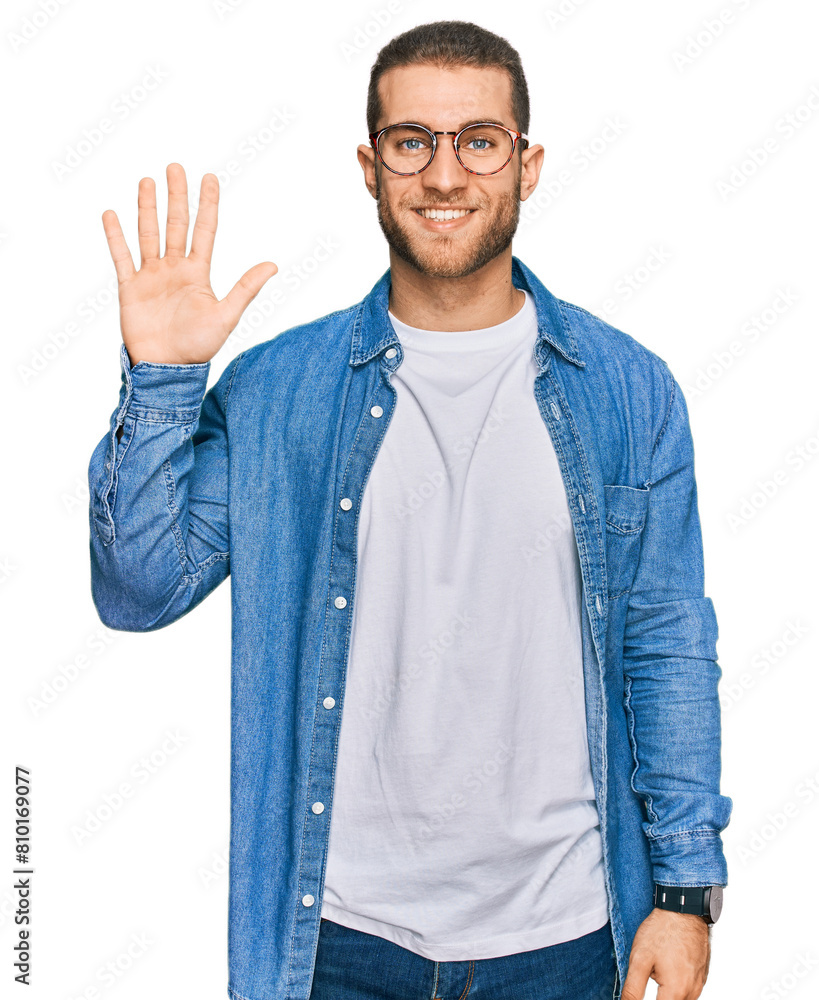 Poster Young caucasian man wearing casual clothes showing and pointing up with fingers number five while smiling confident and happy.