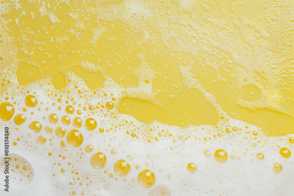 Poster close-up of golden oil bubbles mixed with foam, creating a vibrant and dynamic abstract texture suit