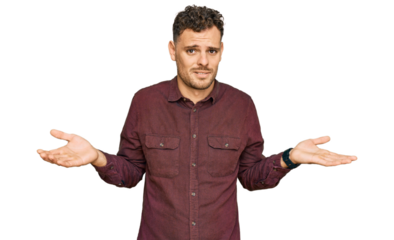 Young hispanic man wearing casual clothes clueless and confused with open arms, no idea concept.