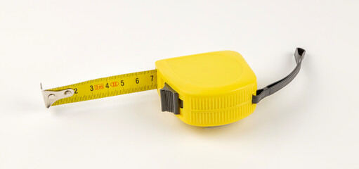 Yellow tape measure. The concept of measuring lengths.