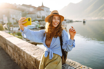 Female tourist taking selfie photos on sightseeing.  Selfie time. Lifestyle, adventure, nature,...