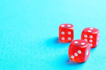 Three red game dices on light blue background, closeup. Space for text