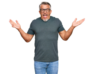 Middle age grey-haired man wearing casual clothes and glasses celebrating victory with happy smile and winner expression with raised hands