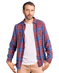 Young handsome man wearing casual clothes skeptic and nervous, frowning upset because of problem....