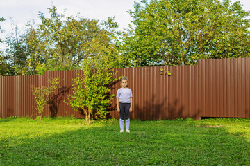 Child Girl Standing Alone in Garden