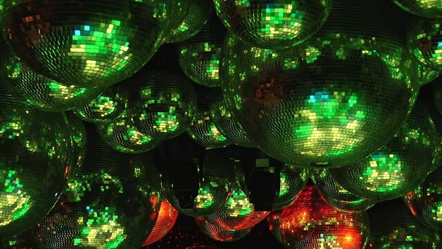 Festive red disco balls creating a warm and inviting atmosphere for celebrations, reflecting vibrant lights. Part of series Disco Balls Illuminated.