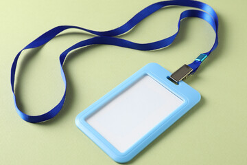 Blank light blue badge with string on green background