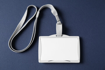 Blank badge with string on blue background, top view