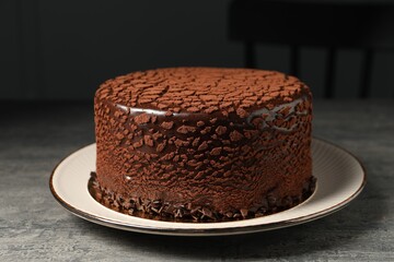 Delicious chocolate truffle cake on grey textured table