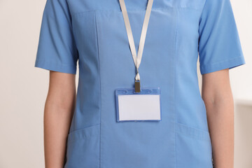 Doctor with blank badge in hospital, closeup