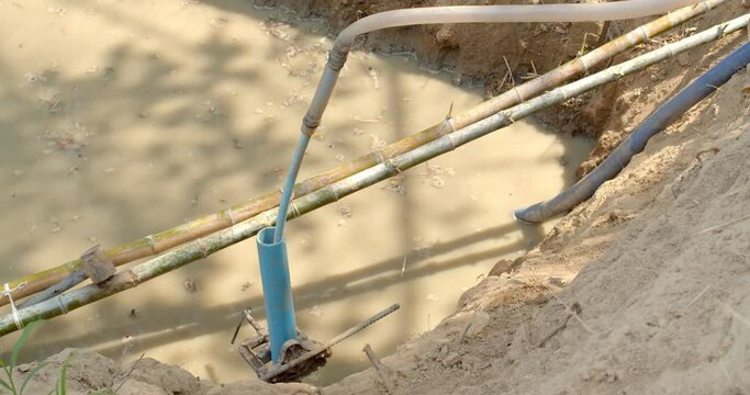 Digging an artesian well.Drilling into the soil to find water in the basement for use in the garden.Farmers search for water underground.