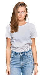Obraz premium Beautiful young blonde woman wearing casual white t shirt depressed and worry for distress, crying angry and afraid. sad expression.