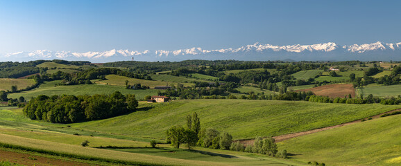 Countryside landscape in the Gers department in southwestern France with the Pyrenees mountains in...