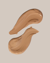 Makeup foundation, beige concealer swatch smudge smear on beige background. BB CC cream texture