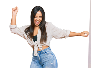 Young beautiful hispanic girl wearing casual clothes dancing happy and cheerful, smiling moving casual and confident listening to music