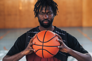 African professional basketball player holding a ball with both hands