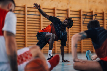 African man professional basketball player stretching and warming up