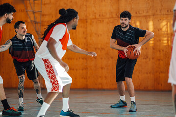 Caucasian player training basketball together with his team during practice
