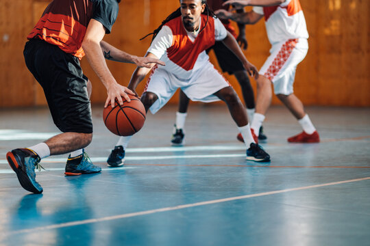 Unrecognizable professional basketball players playing in a basketball court - Powered by Adobe