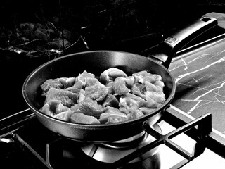 meat fried in a frying pan in the kitchen
