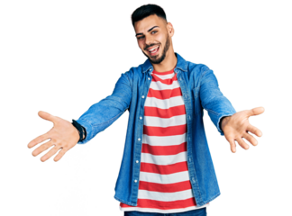 Young hispanic man with beard wearing casual denim jacket smiling cheerful offering hands giving assistance and acceptance.