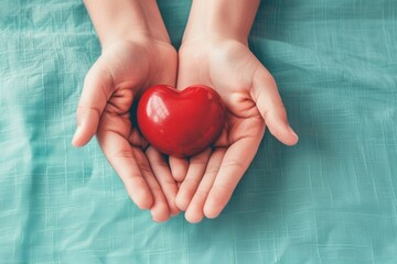 Hands Holding a Red Heart, Symbolizing Love and Charity- World Heart Day Concept
