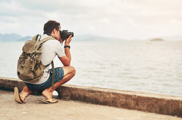 Man, camera and photography at ocean as travel blogger for picture memory for creative, digital or...