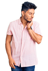 Handsome latin american young man wearing casual summer shirt touching mouth with hand with painful expression because of toothache or dental illness on teeth. dentist