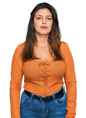 Fototapeta premium Beautiful hispanic woman wearing casual clothes with serious expression on face. simple and natural looking at the camera.