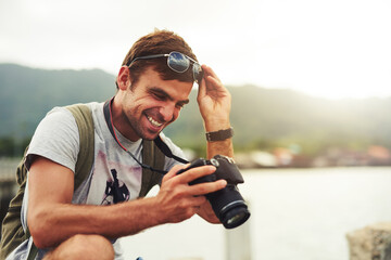 Man, camera and travel photographer at ocean as photo journalist for tourism, hobby or water. Male...