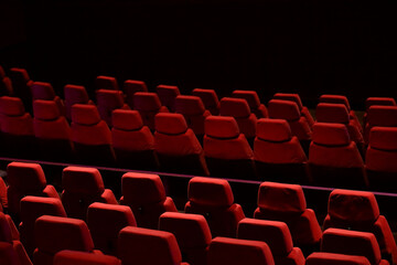 Red seats lined up in the theater