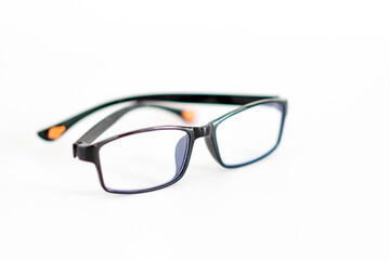 A pair of glasses with blue lenses and orange accents