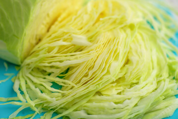 Kitchen preparation: Sliced white cabbage on a cutting surface for a healthy salad