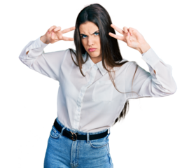 Young brunette teenager doing peace gesture close to eyes skeptic and nervous, frowning upset because of problem. negative person.