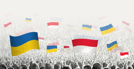 People waving flag of Monaco and Ukraine, symbolizing Monaco solidarity for Ukraine.