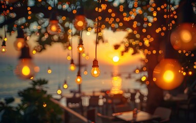 A tree with lights hanging from it and a sunset in the background