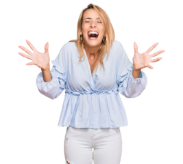 Beautiful blonde business woman wearing casual clothes celebrating mad and crazy for success with arms raised and closed eyes screaming excited. winner concept