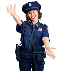Young beautiful girl wearing police uniform looking at the camera smiling with open arms for hug. cheerful expression embracing happiness.