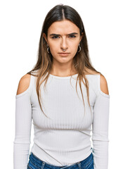 Fototapeta premium Young hispanic woman wearing casual clothes skeptic and nervous, frowning upset because of problem. negative person.