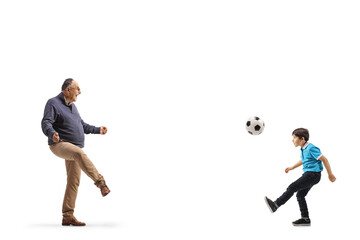 Boy and grandfather kicking football