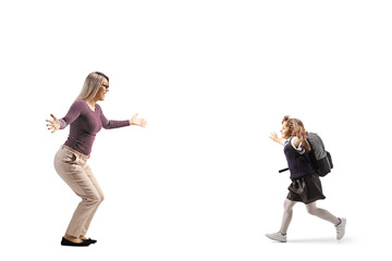 Full length profile shot of a schoolgirl with a backpack running towards a woman