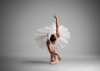 Full length shot of a ballerina dancing and leaning forward