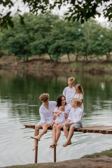 Fototapeta premium large family walks near the lake in the summer