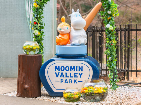 japan, saitama - mar 26 2023: The Japanese Moominvalley park presents at its entrance a photo spot presenting a sculpture of the Moomin characters sitting on an ink pot surrounded by flowers.