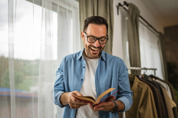 Portrait of adult man read book at living room happy and relax