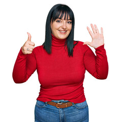 Young hispanic woman wearing casual clothes showing and pointing up with fingers number six while smiling confident and happy.