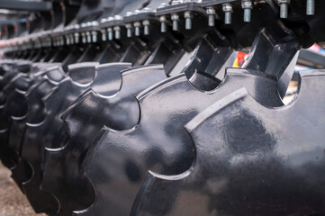 Detailed image showcasing the heavy-duty metal discs on agricultural plowing equipment for soil...