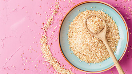 Plate and spoon with healthy quinoa on color background